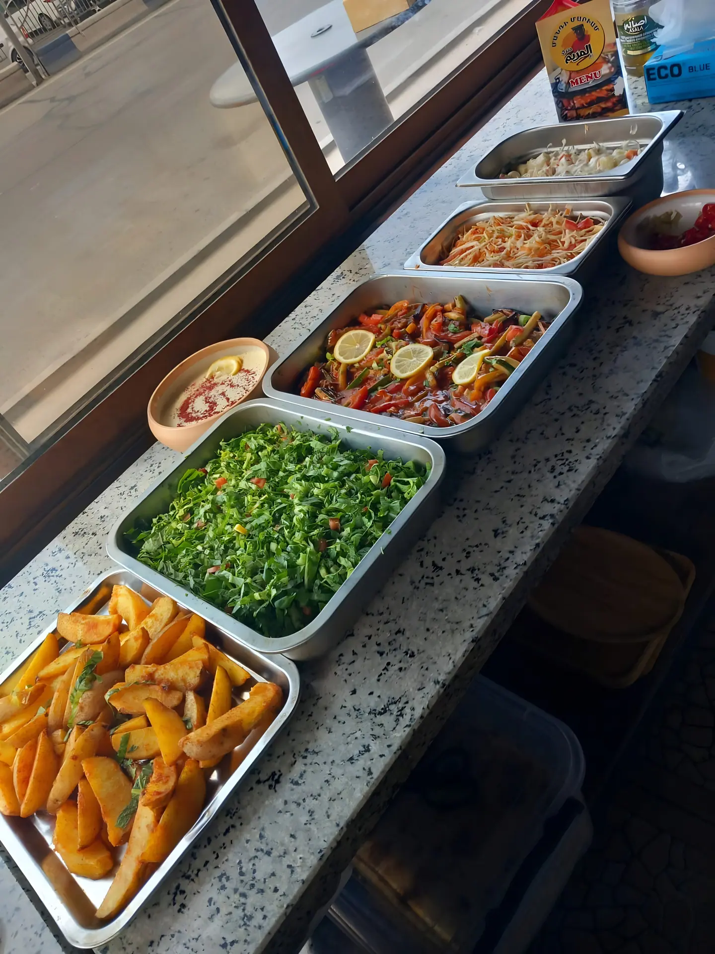 Hot buffet line with trays of Iraqi dishes