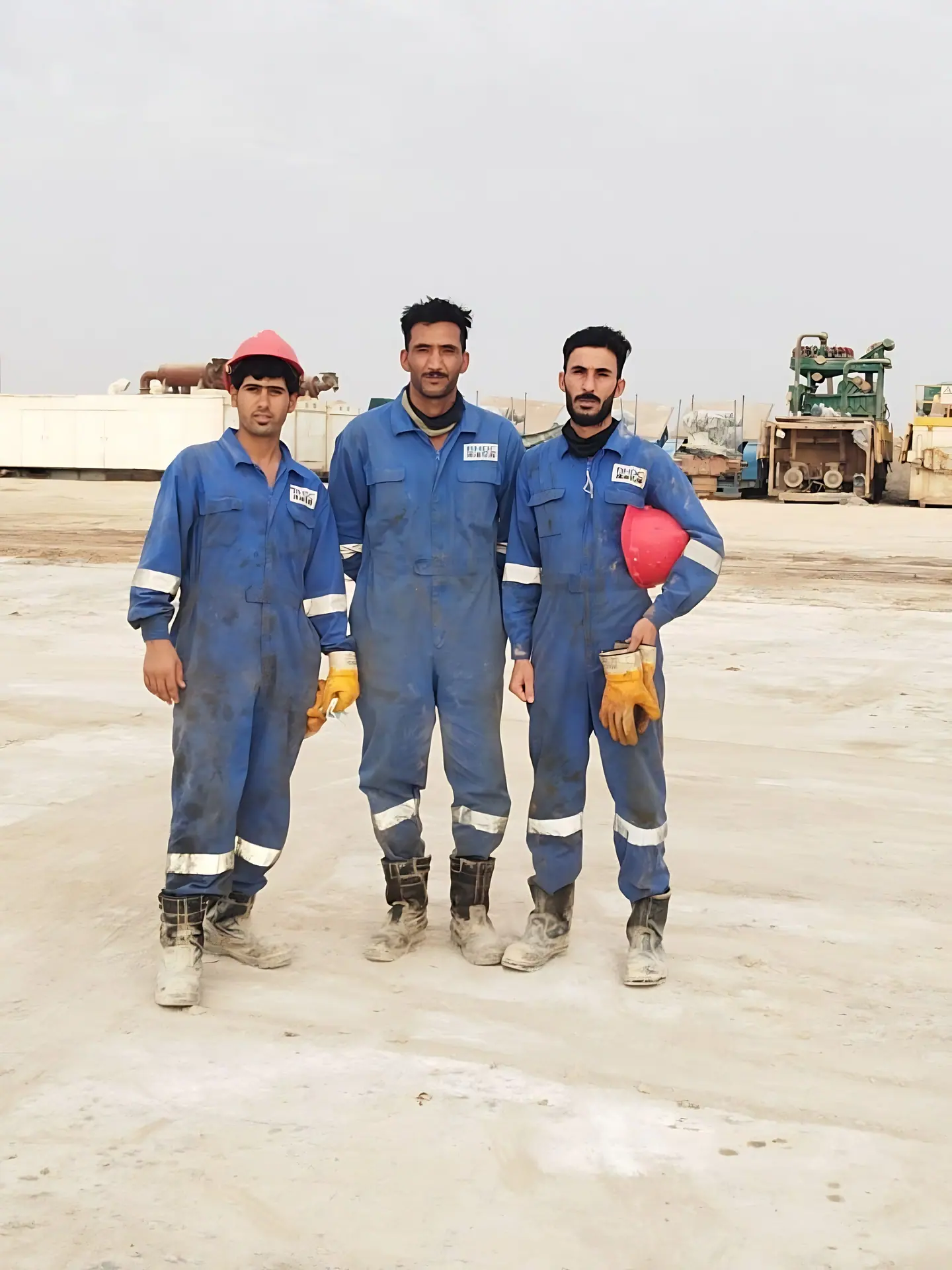 Field crew in coveralls and hard hats on site