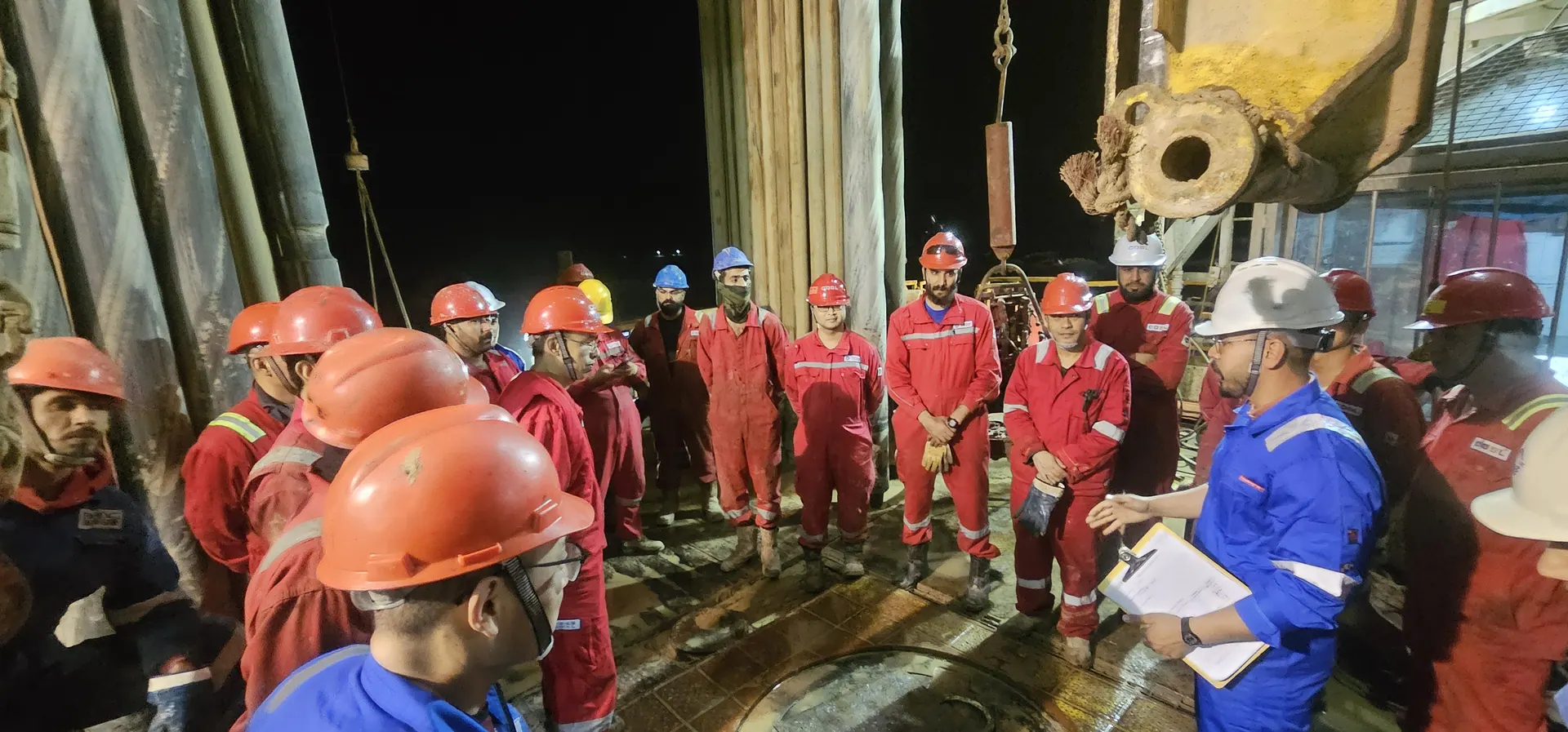 AL-MUTQIN crew during a night safety briefing on the rig floor